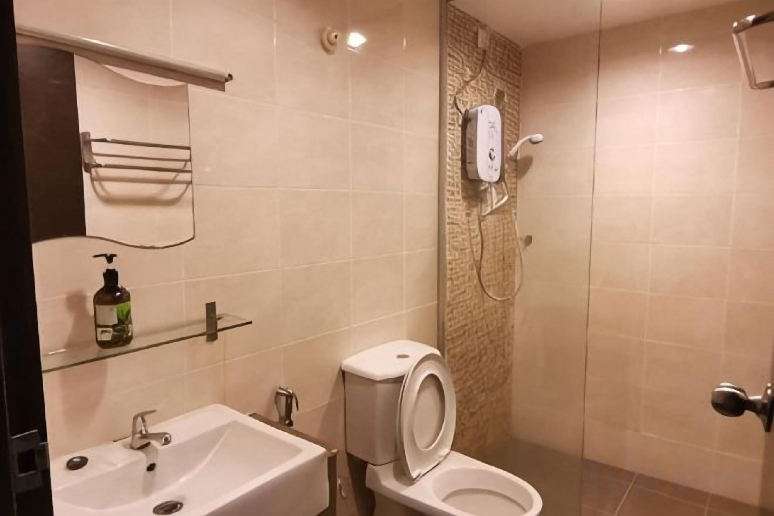 A bathroom with a sink, toilet, and shower.