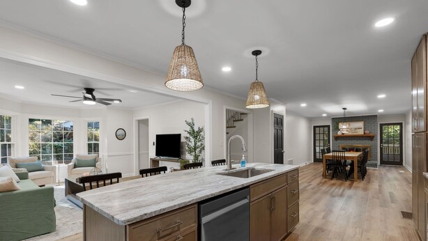 A modern kitchen with a large island, wooden cabinets, and pendant lighting. - Spacious|Close to DT|5 BDRM|4BA|PetsOK (Greenville)