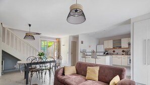 A modern interior with a living area, dining space, and kitchen. - House - Le Clos Des Pommiers (Pleudihen-sur-Rance)