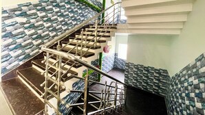 A staircase with a modern design, featuring a metal railing and patterned walls. - New Beach Resort - near Sea Beach (Brahmagiri)