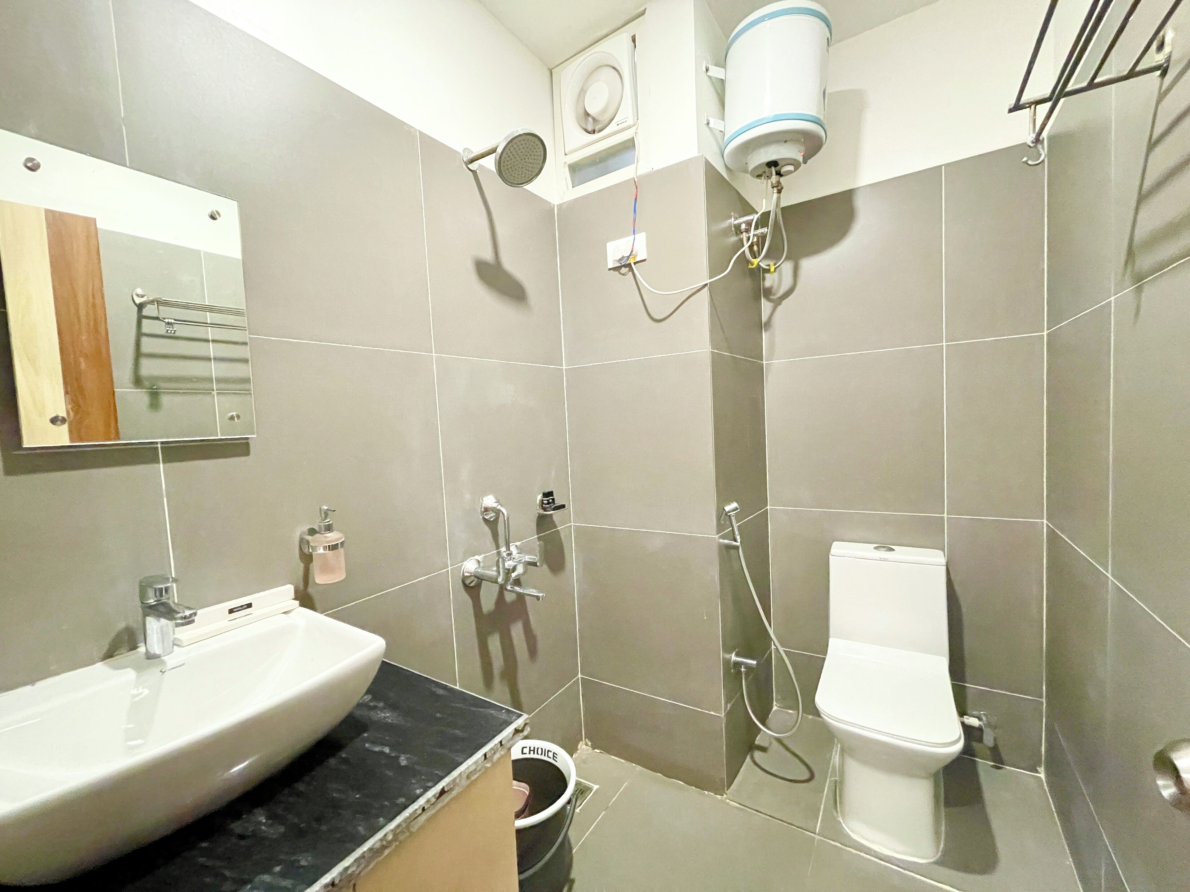 A bathroom with a sink, toilet, and shower.