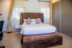 Family Cottage, Garden View | In-room safe, desk, laptop workspace, iron/ironing board - Olivoak Villa (Harare)