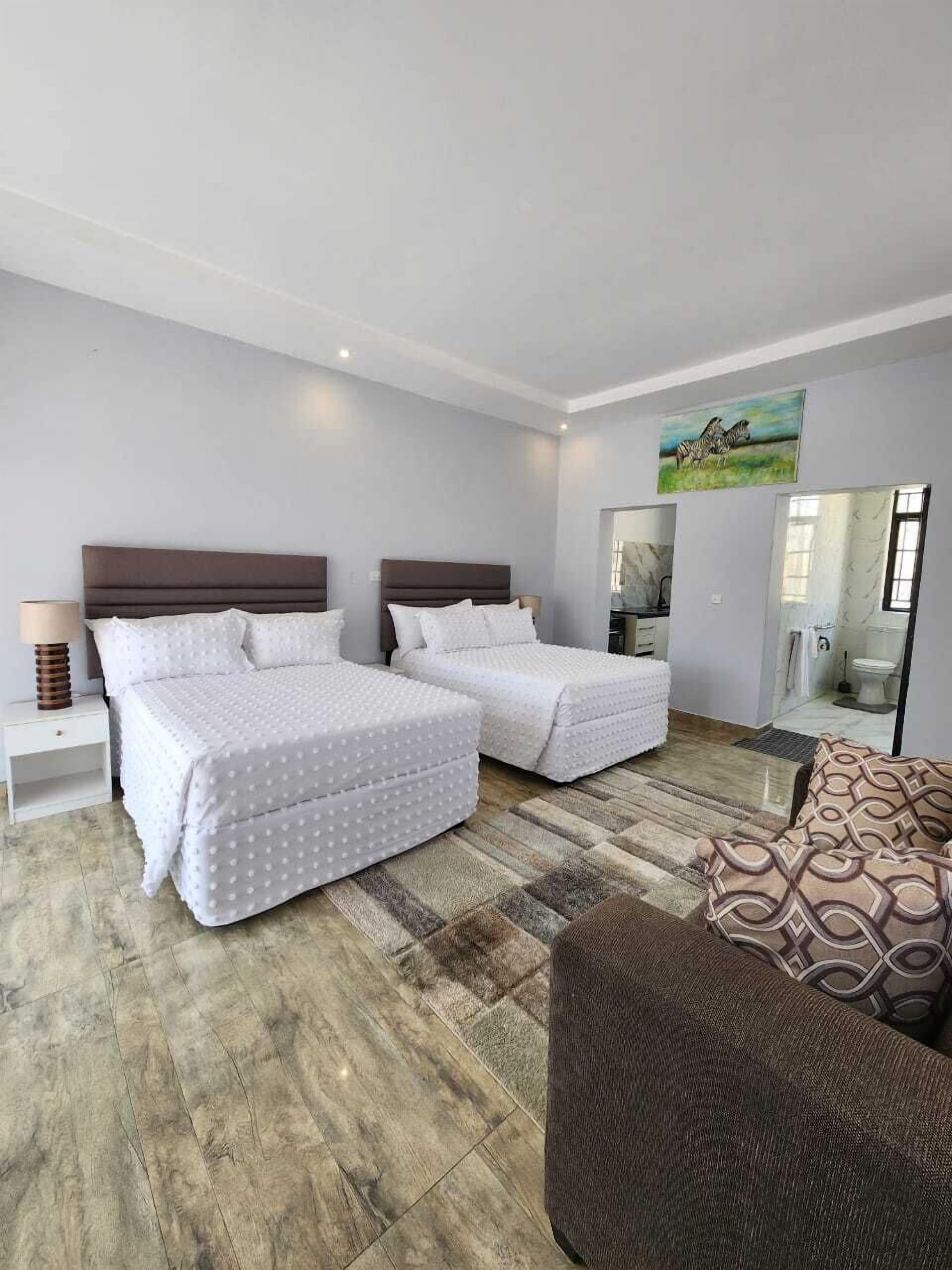 Family Suite, Garden View | In-room safe, desk, laptop workspace, iron/ironing board