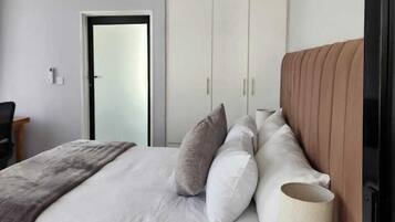 Deluxe Room, Garden View | In-room safe, desk, laptop workspace, iron/ironing board