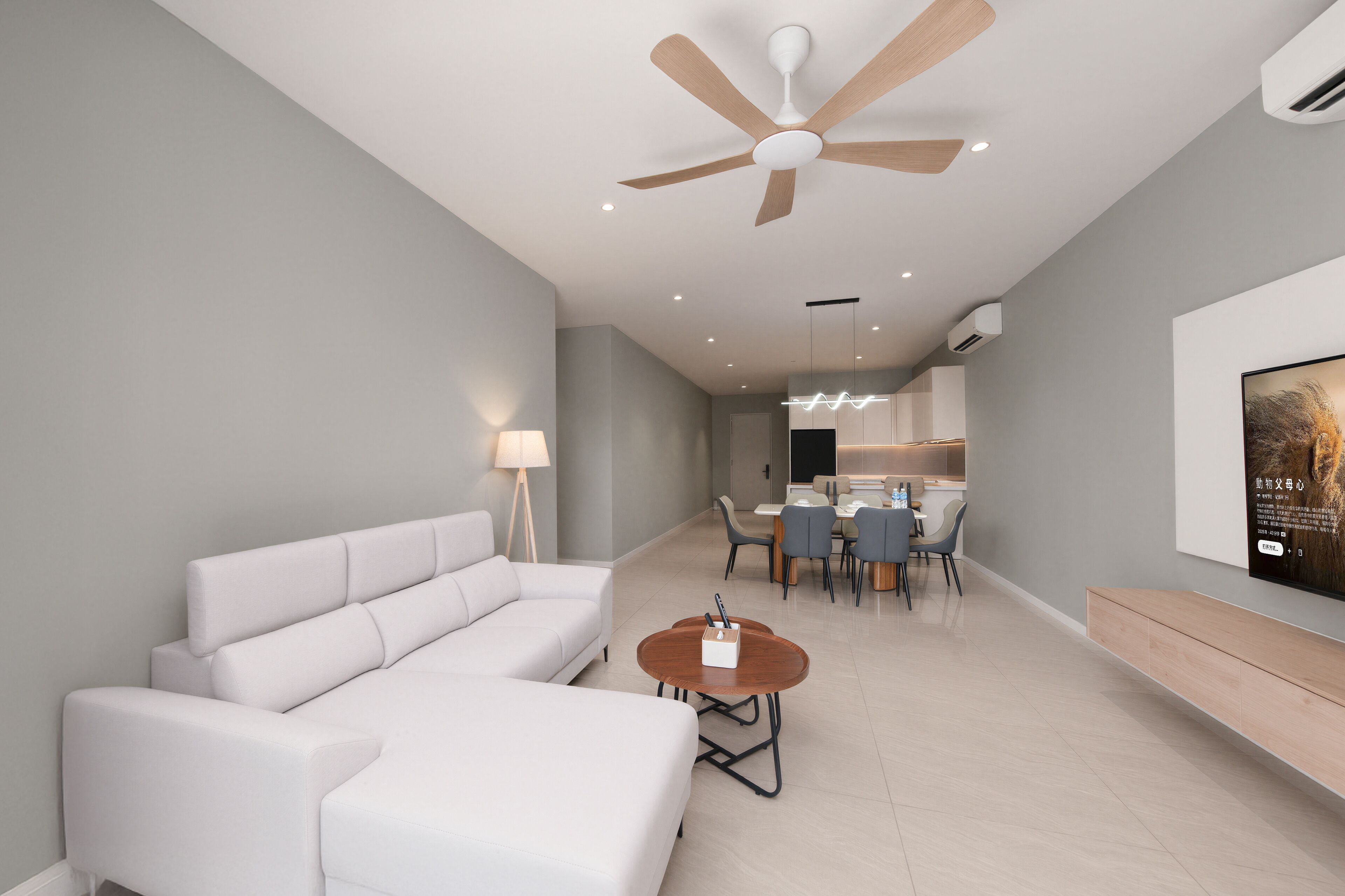 A modern living room with a white sectional sofa, a wooden coffee table, and a ceiling fan.