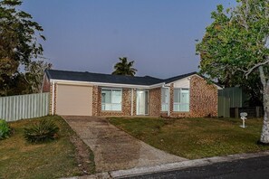 A single-story house with a garage, a front yard, and a mailbox.