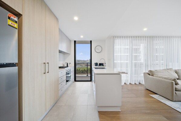 Apartment | Private kitchen | Fridge, microwave, oven, stovetop - 2-bed Haven: Impeccable Interiors & Chic Amenities (Canberra)