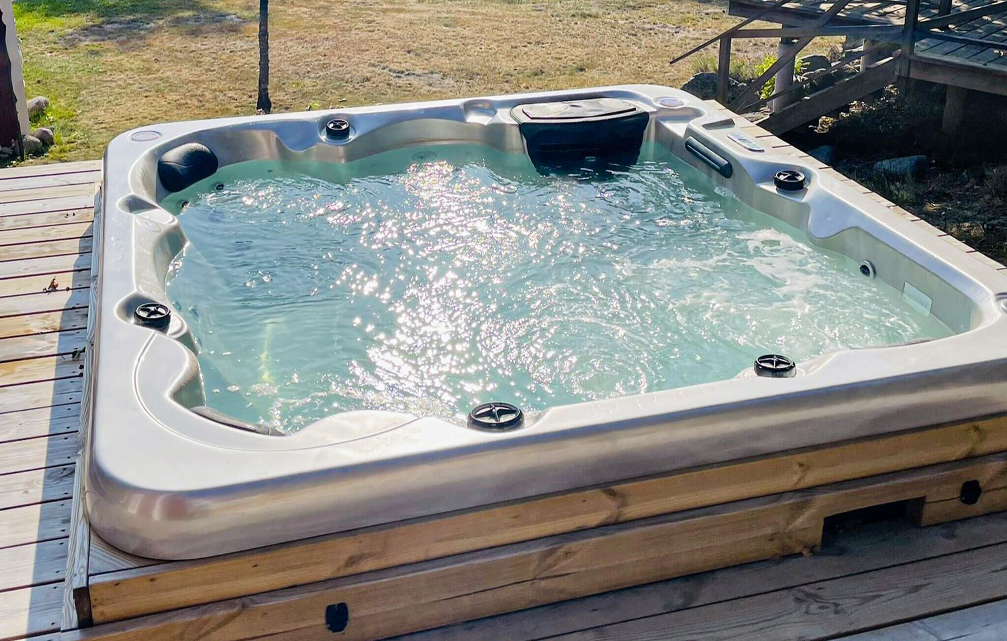 A hot tub on a wooden deck.