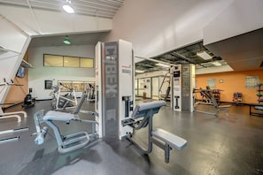 A gym with various exercise equipment, including treadmills and weight machines.