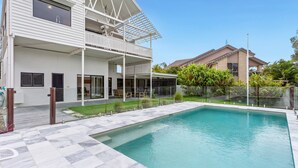 A modern two-story house with a swimming pool, a covered patio, and a well-maintained garden. - Beachfront 3-bed With Private Pool & Fireplace (Sunshine Coast)