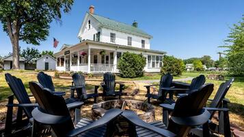 A house with a porch, outdoor seating, and a flag.