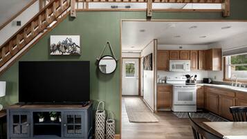 A modern kitchen with wooden cabinets, a microwave, and a stove.
