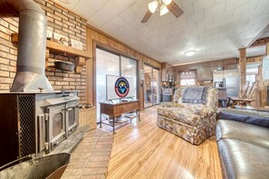 A cozy living room with a fireplace, a sofa, and a dining area.