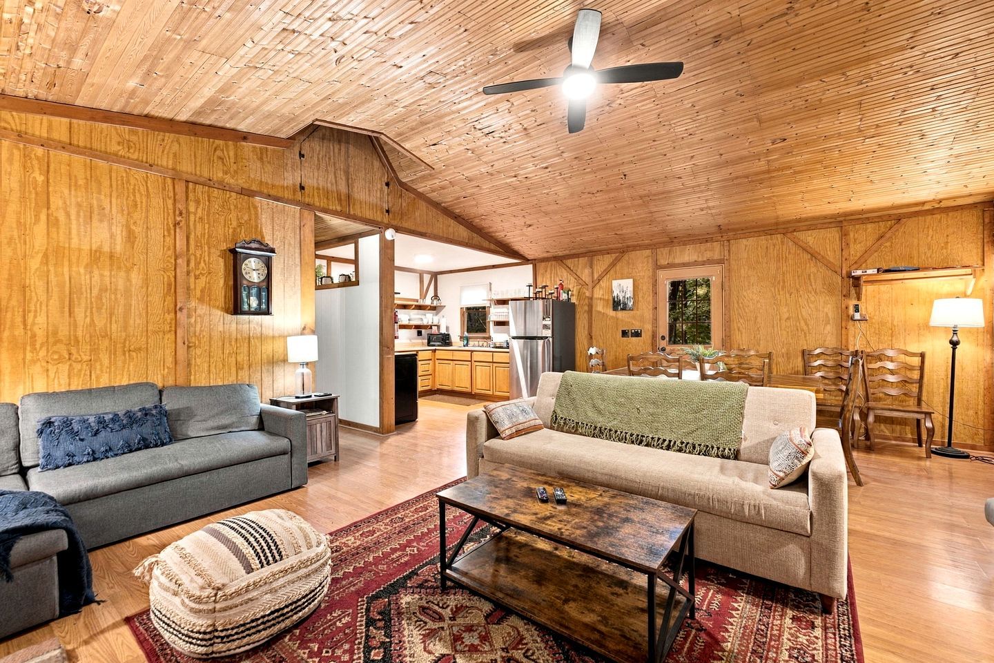 A cozy living room with a sofa, a coffee table, and a patterned rug.