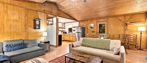 A cozy living room with a sofa, a coffee table, and a patterned rug.