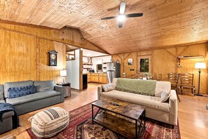 A cozy living room with a sofa, a coffee table, and a patterned rug.