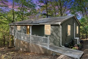 A small cabin with a porch, a ramp, and a window. - Cozy Modern Cabin with Fire Pit & Trail Access near Berkeley Springs, West Virginia (Hedgesville)
