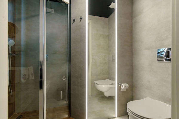 Shower, hair dryer, slippers, towels