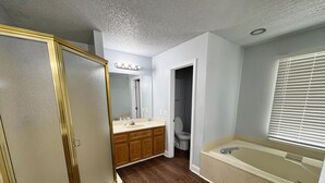 A bathroom with a vanity, sink, mirror, and bathtub. - Bright & Roomy 4BR/5-Bed Home Just Off Dorchester (North Charleston)