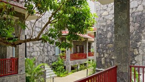 A stone building with balconies and a staircase. - Holiday Ranakpur (Desuri)
