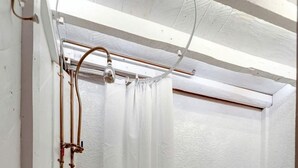 A small bathroom with a shower, toilet, and a sink.