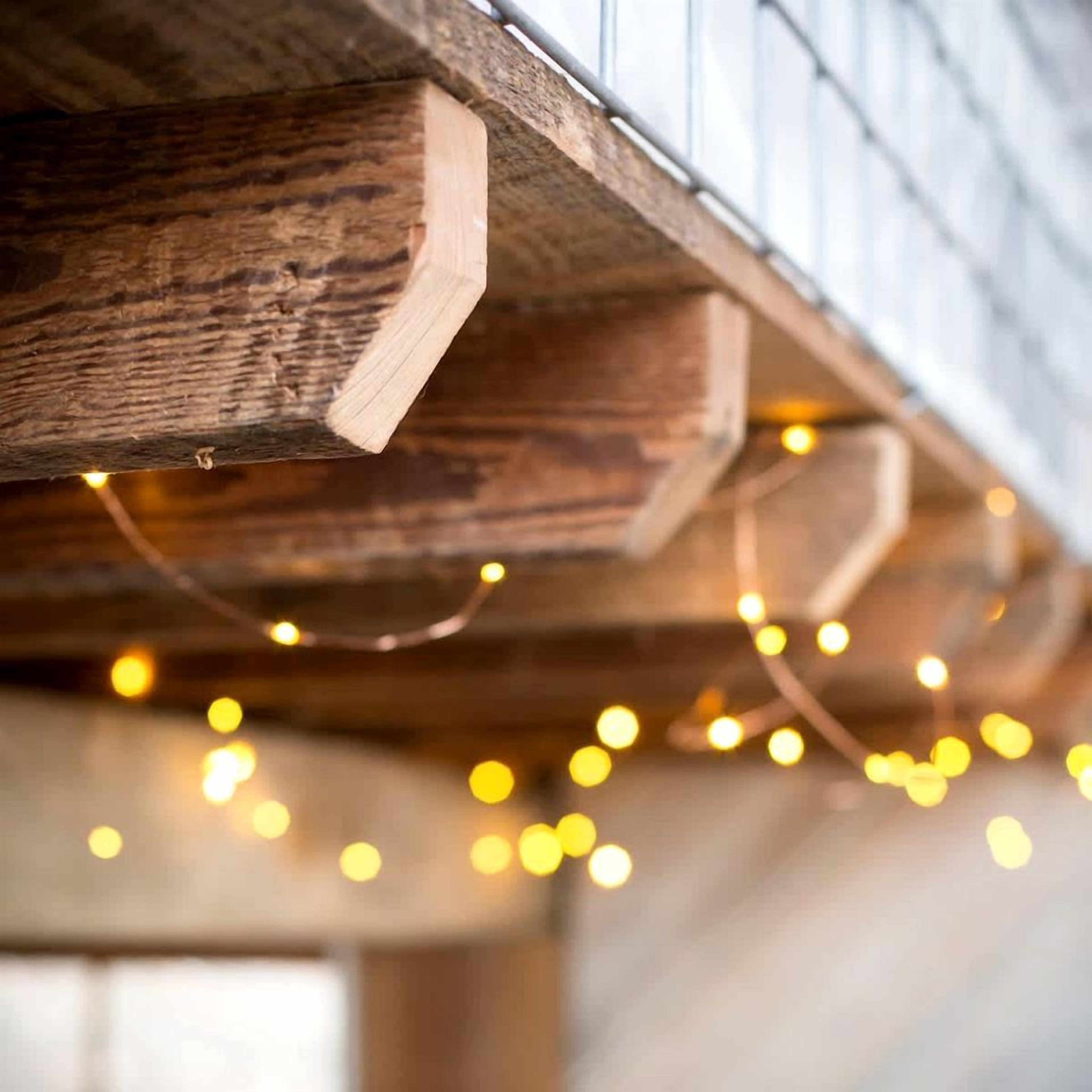 A wooden beam structure with string lights.