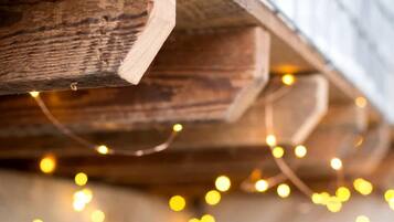 A wooden beam structure with string lights.