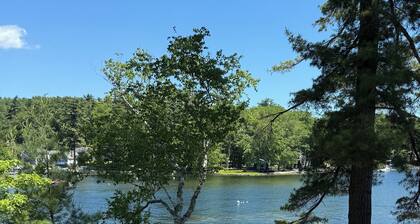 Sebago Lake studio-style condo with enclosed sunroom and sunset views