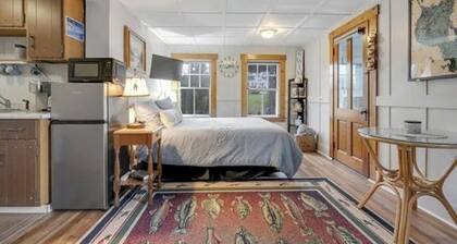 Sebago Lake studio-style condo with enclosed sunroom and sunset views