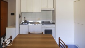 A compact kitchen with white cabinets, a stainless steel sink, and a dishwasher. - The apartments, all studios, are simply and functionally furnished and all consist of a living room (Marina di Campo)