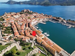 An aerial view of a coastal town with historic buildings, a marina, and a fortification. - We offer a nice and bright apartment, within the walls of the Medici. Strategic position for those w (Portoferraio)
