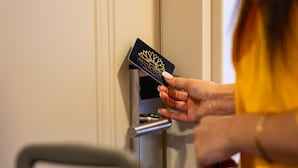 A person using a key card to unlock a door. - Ayçiçeği Comfort Hotel (Edirne)