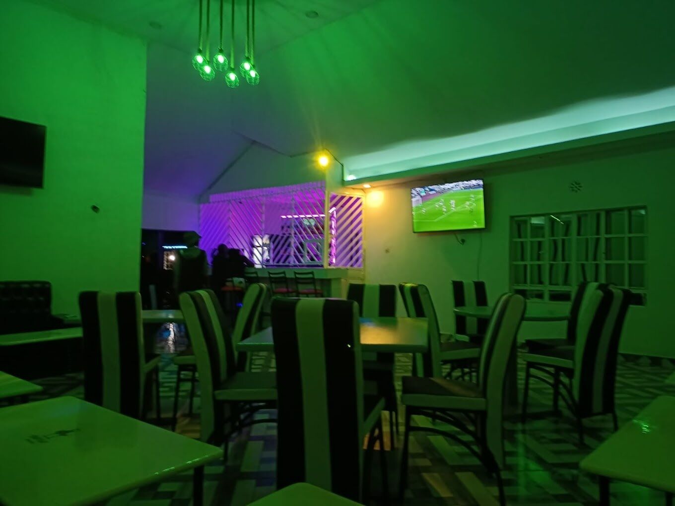 A restaurant with tables and chairs arranged for dining.