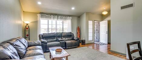 A living room with a sectional sofa, a coffee table, and a rug.