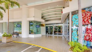A spacious indoor area with a curved ceiling, benches, and a display of clothing. - Walkable Urban Retreat! Condo in Honolulu (Honolulu)
