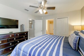 A bedroom with a bed, dresser, TV, and ceiling fan. - Championsgate Resort Perks! Fun-filled Family Home (Davenport)