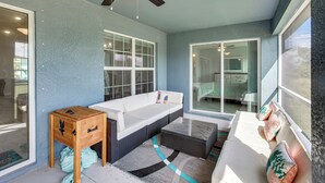 A modern bathroom with a bathtub, a wooden side table, and a window with a view of the outside. - Fish, Golf & Beach-hop! Family Home in Cape Coral (Cape Coral)