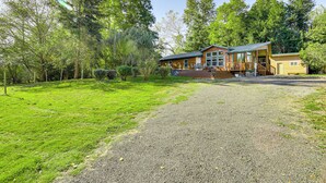 A two-story house with a covered porch and a gravel driveway. - Hike, Ski, Fish & Bike: Bellingham All-season Base (Bellingham)