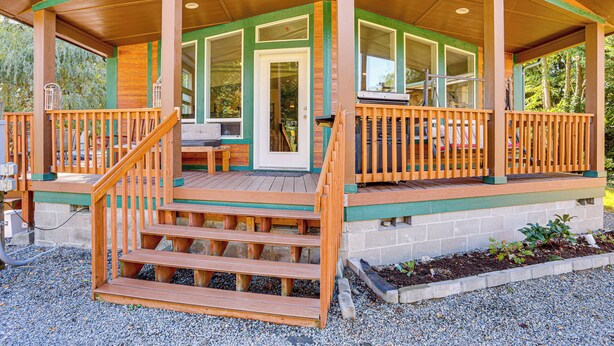 A wooden cabin with a porch, steps, and a door. - Hike, Ski, Fish & Bike: Bellingham All-season Base (Bellingham)