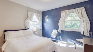 A bedroom with a bed, two windows with curtains, a night sky mural, a chair, and a desk. - Jackson Home w/ Fire Pit: Near Parks & Downtown! (Jackson)