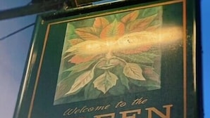 A sign with a bird and the text "Welcome to the Green Man." - The Green Man (Dunchurch)