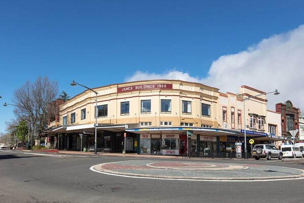 A building with a sign reading "James' Buildings 1925" and storefronts below. - Explore the Blue Mountains on Foot (Katoomba)