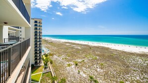 A high-rise hotel with balconies overlooking a beach and ocean. - Phoenix Vi 61010 2 Bedroom Condo (Orange Beach)