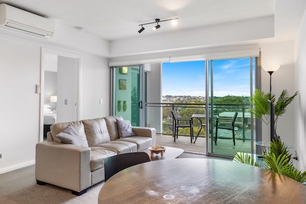 Apartment | Living room - Feel The Sea Breeze: 1-bed With Pool, Gym & Views (Redcliffe)
