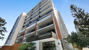 A multi-story building with a sign reading "ESSENTIA SURFERS PARADISE". - Surfers Paradise 2-bed Flat With Luxury Amenities (Gold Coast)