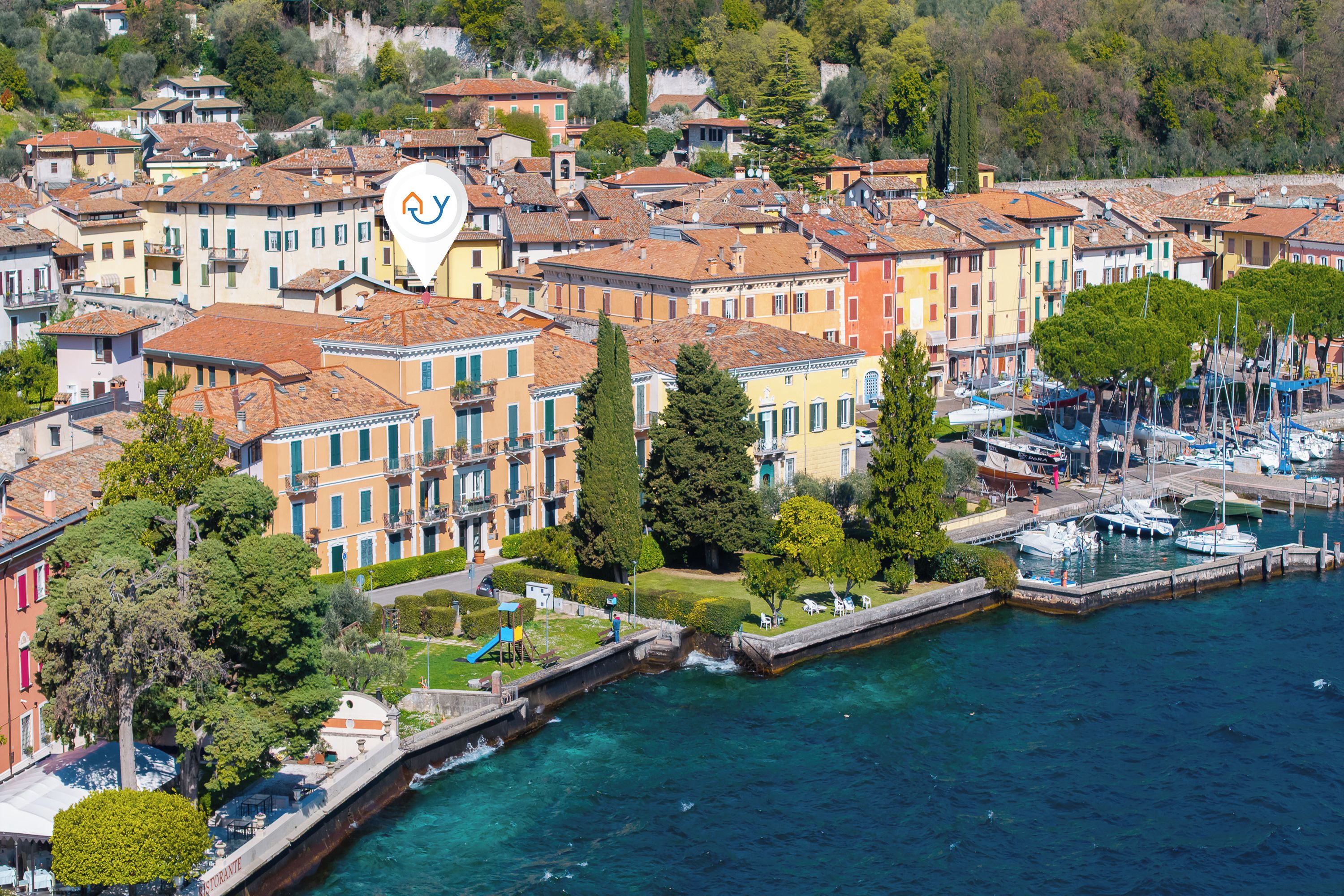 A coastal town with colorful buildings, a marina, and a clear waterfront.