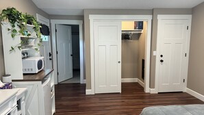 A bedroom with a bed, a dresser, a microwave, and a plant. - Private room and bathroom in safe Vancouver neighborhood (Vancouver)