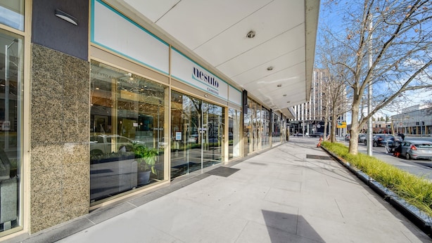 A modern building with a glass facade and a sign reading "nesuto Canberra." - Center 1-bed With Sauna, Gym, BBQ & Parking (Canberra)