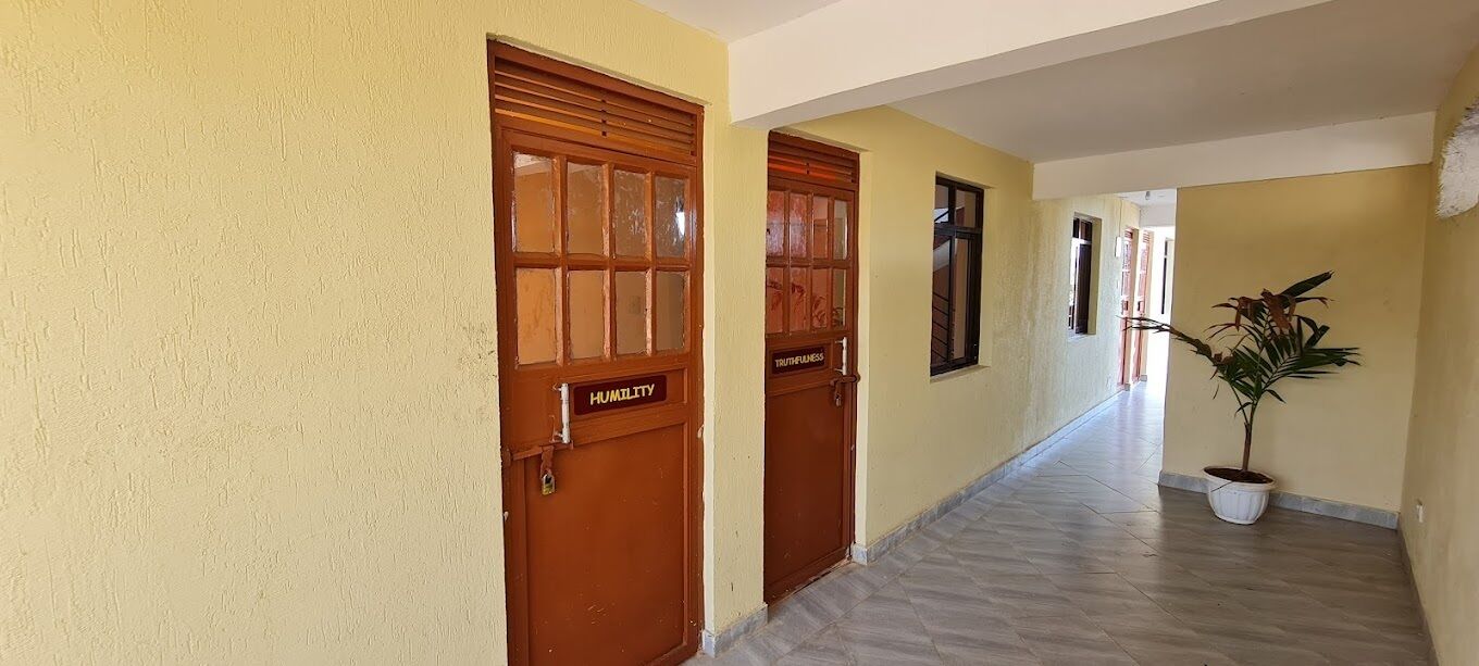 A hallway with two wooden doors labeled "TRUTHFULNESS" and "HUMILITY."