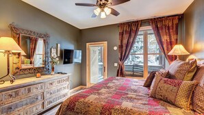 A bedroom with a large bed, a ceiling fan, a dresser, and a window with curtains. - Ski •Soak •Savor Haven – Private Hot Tub, Private Garage - Walk to Lifts & Town (Breckenridge)